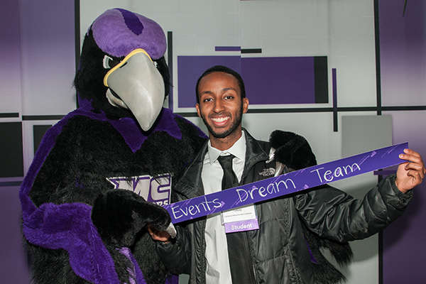 aces student posing for a photo with the MC raptor