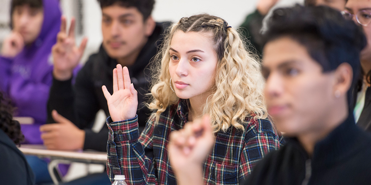 a students raising their hand in a ACES High School Workshop