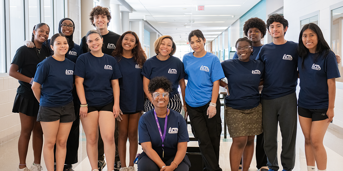 A group of Wheaton High School Volunteers and Coordinators smiling and posing for a picture