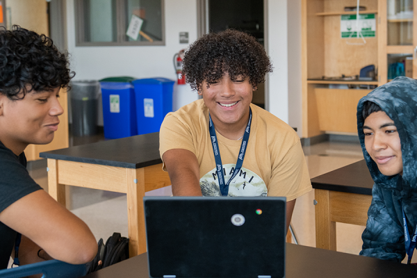 Three Students At Wheaton High School Looking At A Computer