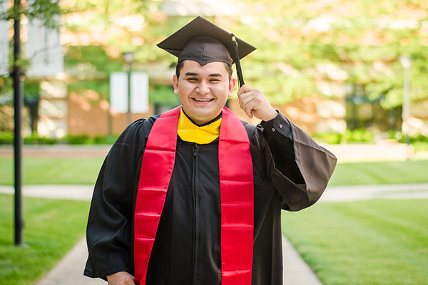 ACES Graduate Holding Tassel Smiling